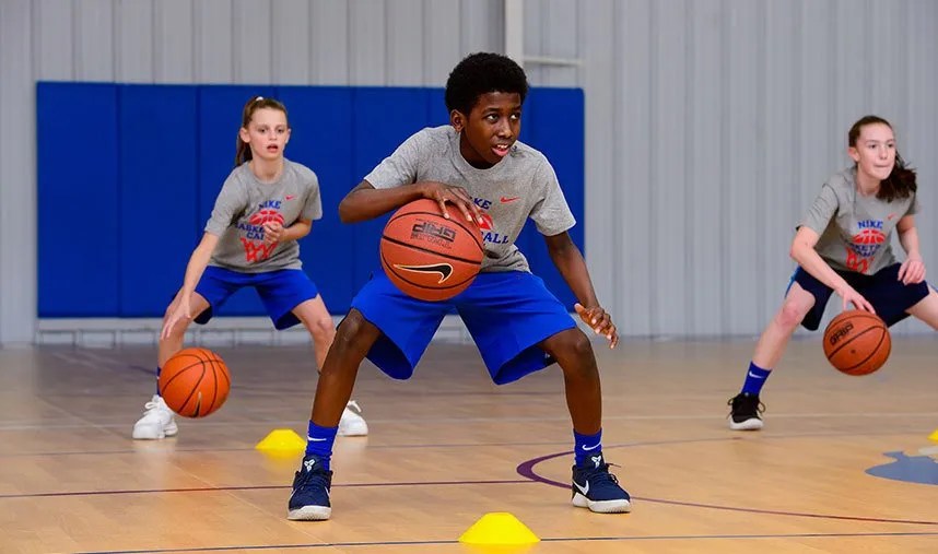 Young players practicing ball handling in a gym